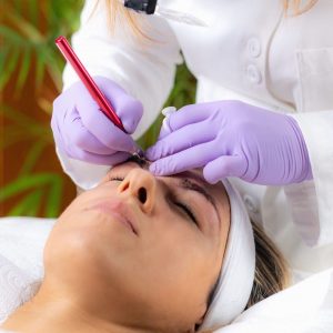 Beautician Microblading Eyebrows in Beauty Salon