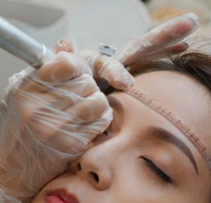 Woman undergo eyebrow microblading, permanent makeup